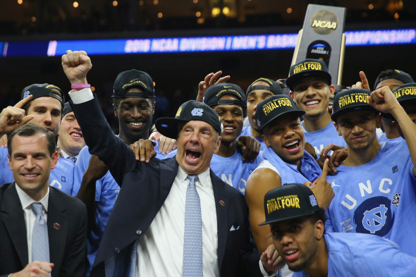 PHILADELPHIA, PA - MARCH 27: Head coach Roy Williams of the North Carolina Tar Heels celebrate with his team after defeating the Notre Dame Fighting Irish with a score of 74 to 88 in the 2016 NCAA Men's Basketball Tournament East Regional Final at Wells Fargo Center (Photo by Elsa/Getty Images)